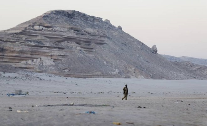 A Somali government soldier walks on the beach in Eyl, in Somalia's semiautonomous northeastern state of Puntland, in March. | AP